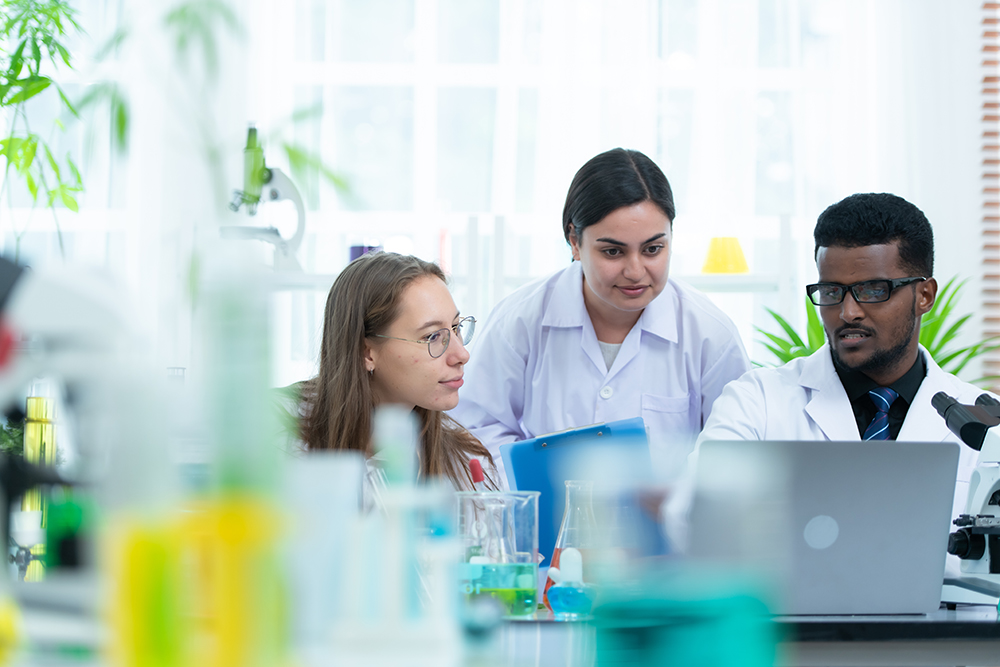 Researchers analyzing in a university science lab